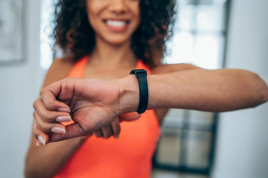 A lady looking at her smartwatch