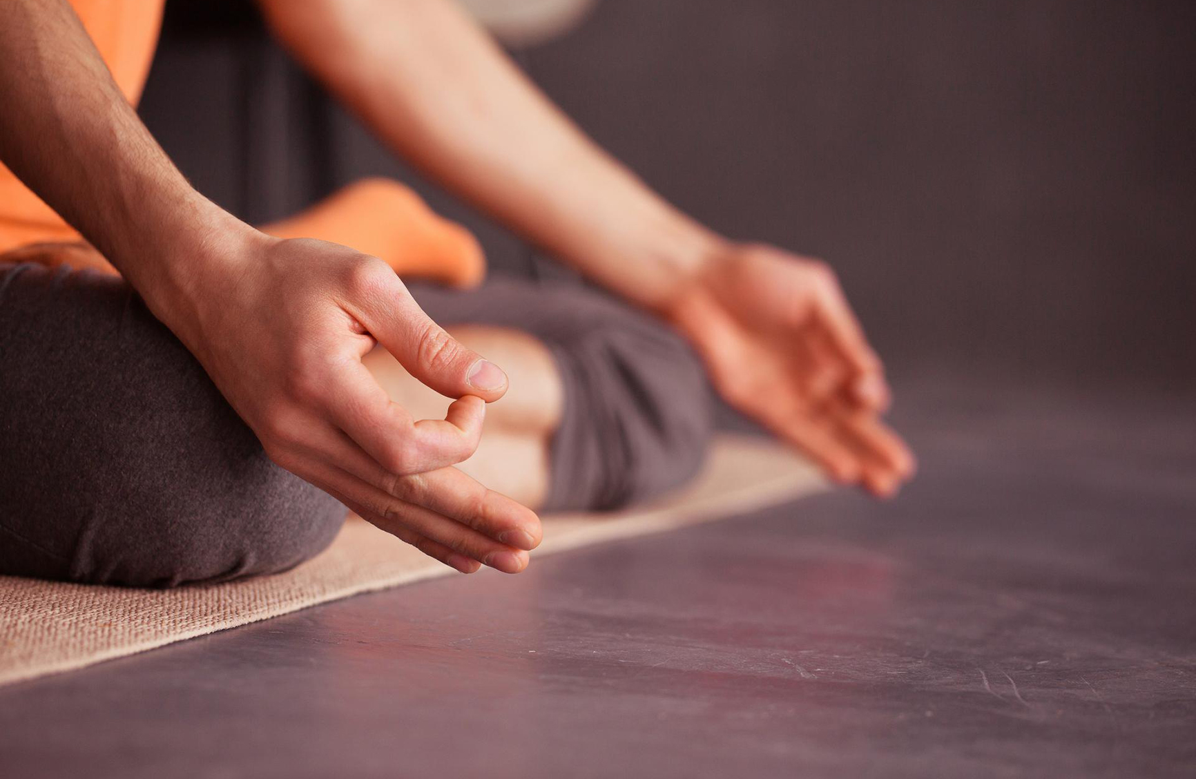 a veiw of a mans hands while he meditates