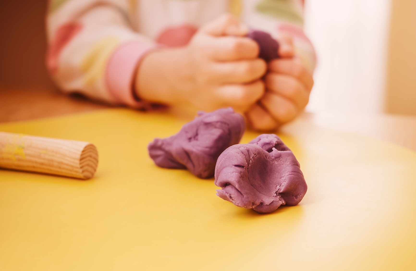Child's hands kneading modelling clay