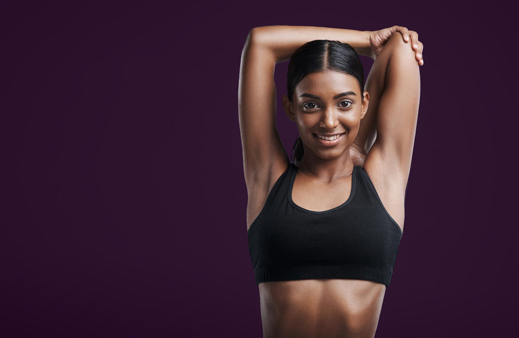 young black woman stretching before a workout