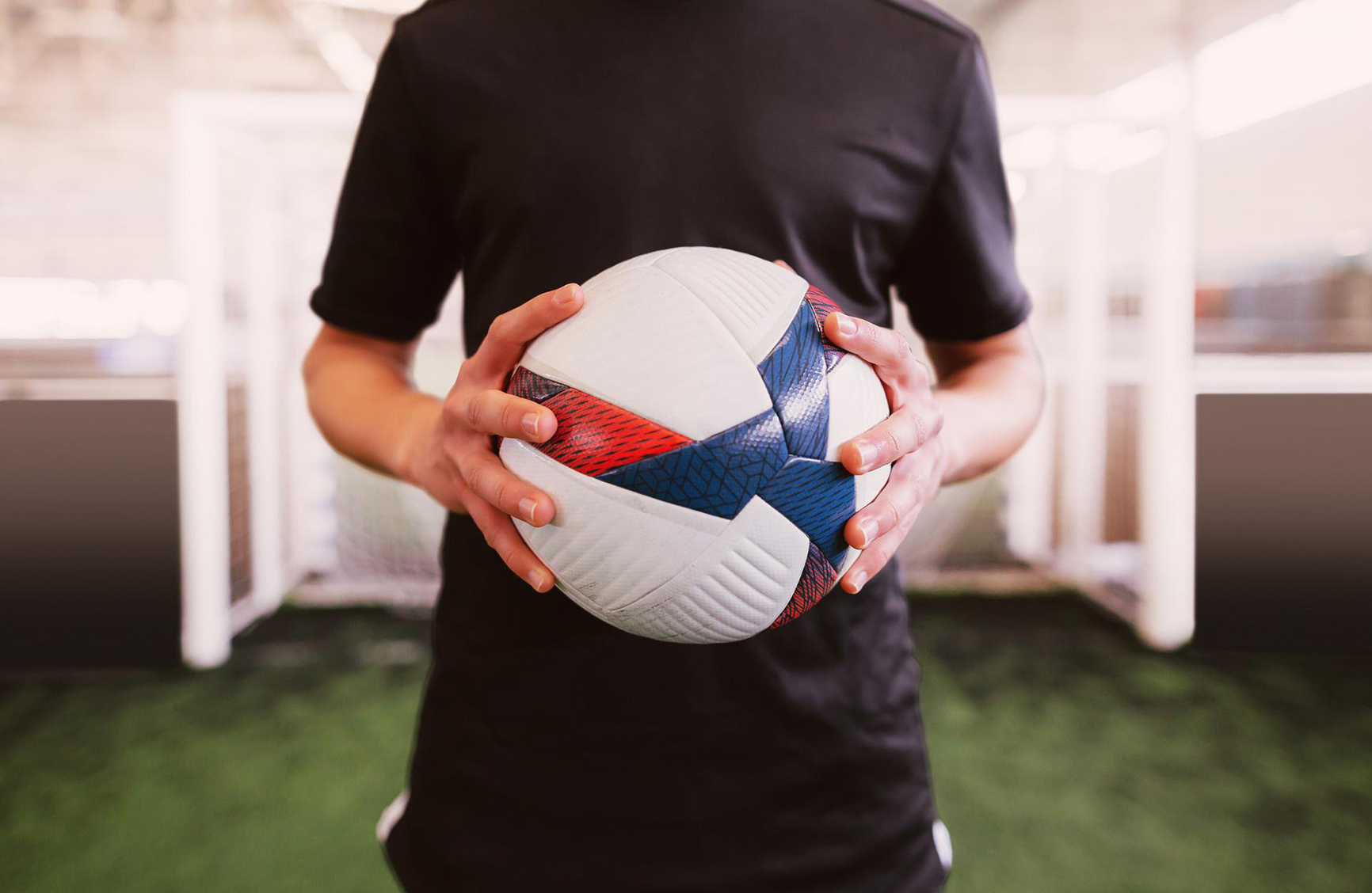 a young man holding onto a football