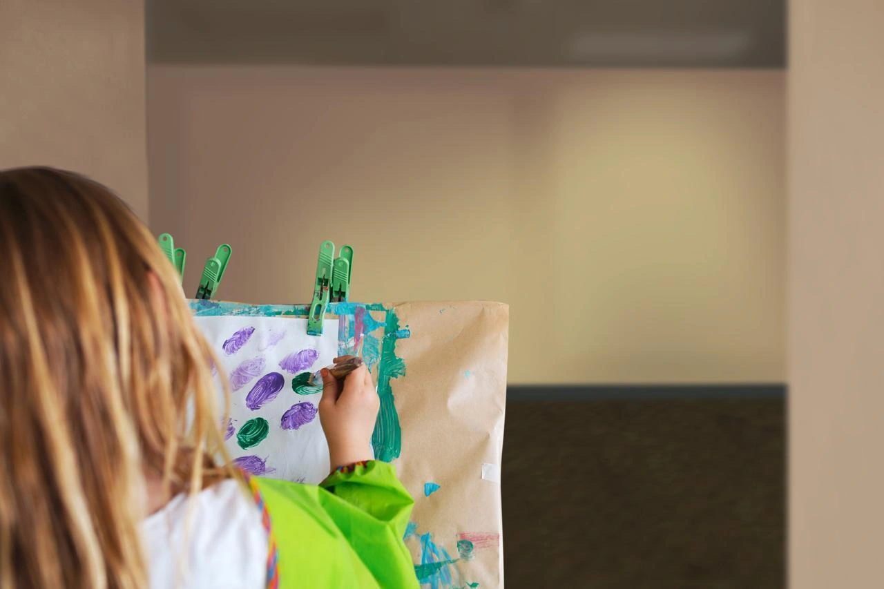 A girl doing painting at nursery